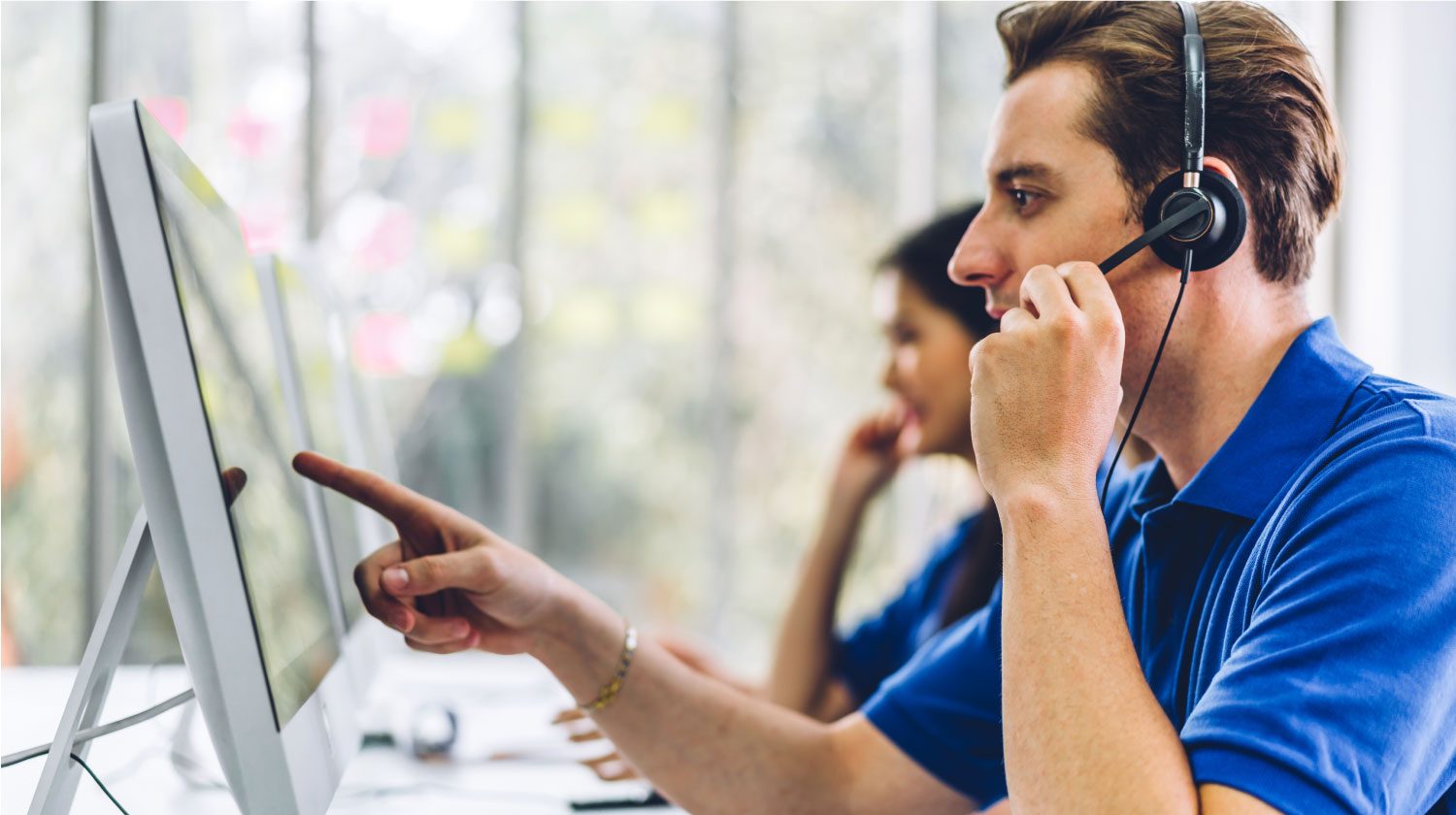 a cheerful man answering the telephone in an office