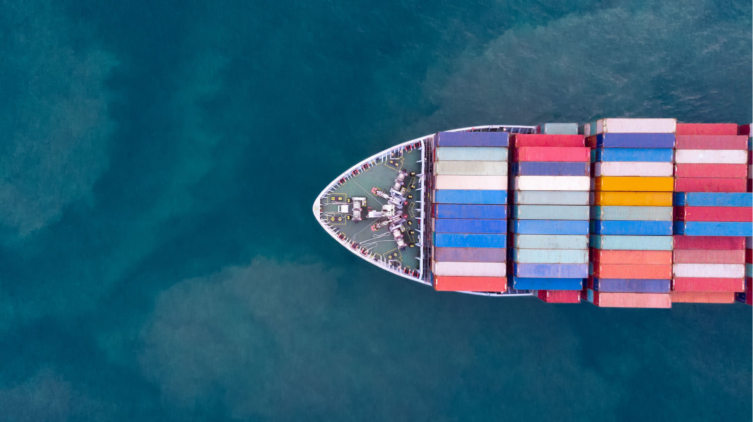 an aerial view of a laden container ship
