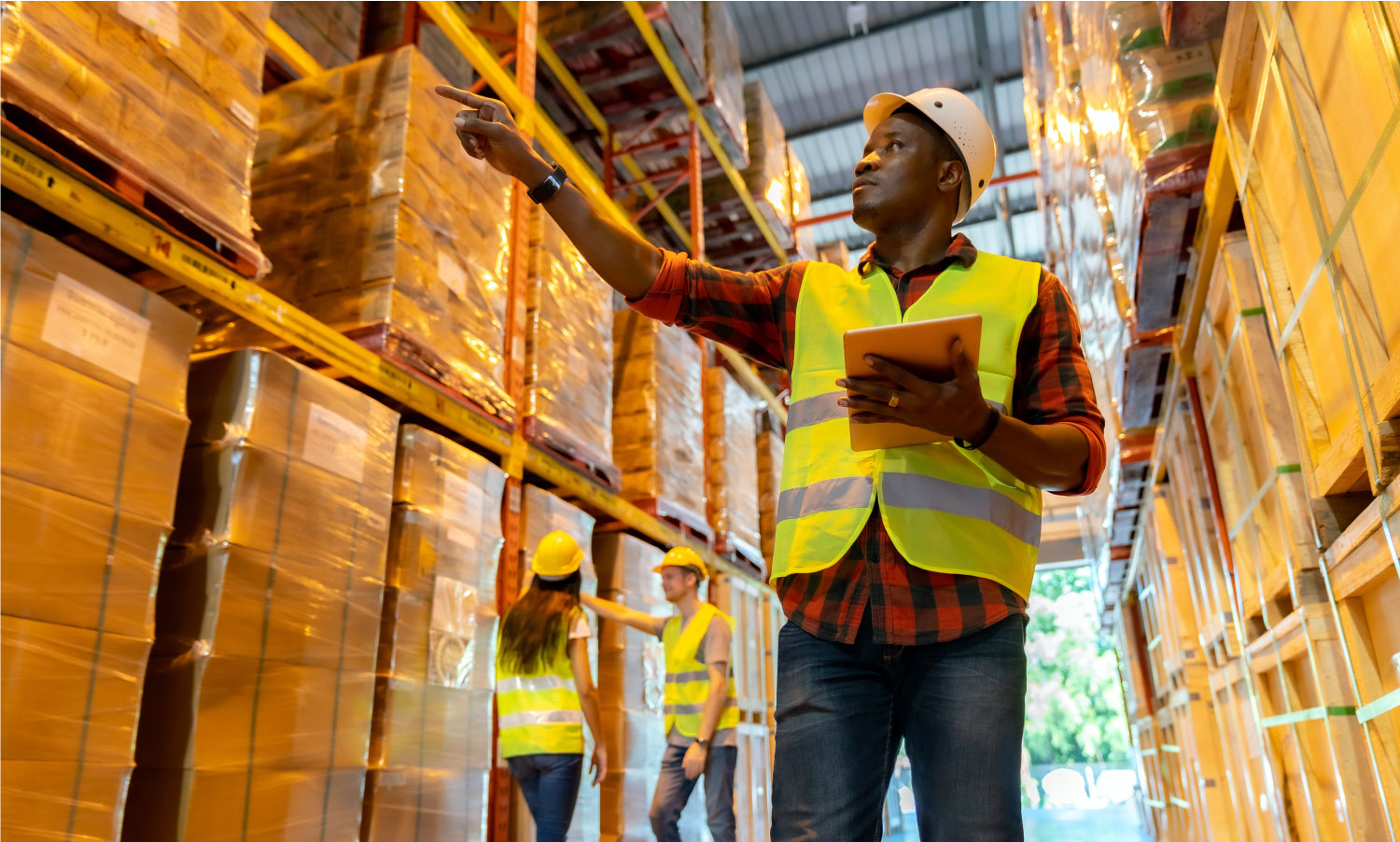 a man in a hi-vis jacket working in a warehouse